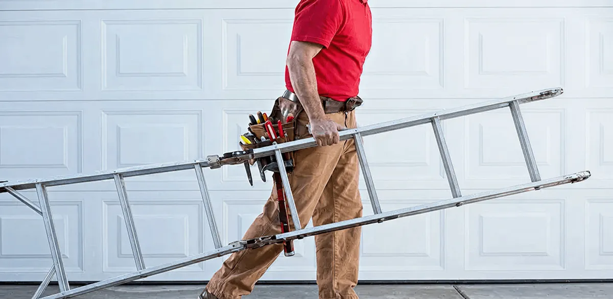Garage door repair technician arriving with tools and ladder in Tuscaloosa, AL